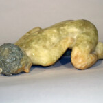 Nicolas Africano creates scaled, life-size and larger-than-life figures in cast glass. The primary subject of his sculpture is his wife and muse, Rebecca, of whom Sleeping Girl is likely based. 
Gift of Lynde B. Uihlein Nicolas Africano (American, b.1948), Sleeping Girl, 1990. Cast glass with oil, water seal.