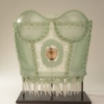 "For years I believed my work was about myself. But ultimately my work is about my Mother. With the sewing and cooking skills she passed on, I am able to indulge my own notions of domestic role-playing. My work embraces the feminine ideals of sewing and cooking, but in a contrary material, offering conflicting messages of comfort and expectation." - Susan Taylor Glasgow
Museum purchase with gift support from the Betty Smith Memorial Fund and contributions from Fred and Sharon Schomer, Bonnie Marx and Bud and Libby Hoffman. Susan Taylor Glasgow (American, b.1958), Eve's Penance, 2005. Fused, draped, enameled, and sandblasted glass with waxed linen and nylon.