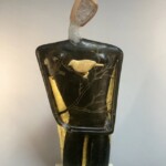 Robin Grebe often takes her inspiration for form from Greek Cycladic fertility goddesses dating to the Bronze Age. Seemingly strong and yet somehow fragile, to her, these works illustrate the daily paradoxes of human existence.
Gift from the collection of Herbert and Jane Rozoff Robin Grebe (American, b.1957). Into the Night, c.1999. Cast glass, wood, ceramic glaze, gold leaf and marble.
