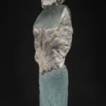 The abstract figurative forms created by New Hampshire artist Thomas Scoon incorporate self-gathered natural stone, minerals and metals with cast glass. By pairing or grouping these forms (see Mate #2), Scoon explores familial and generational relationships in an attempt to convey personal narrative.
Gift from the collection of Jane Humzy and Peter D. Debreceny Thomas Scoon (American, b.1961), White Lives #4, 1996. Cast glass and quartz.